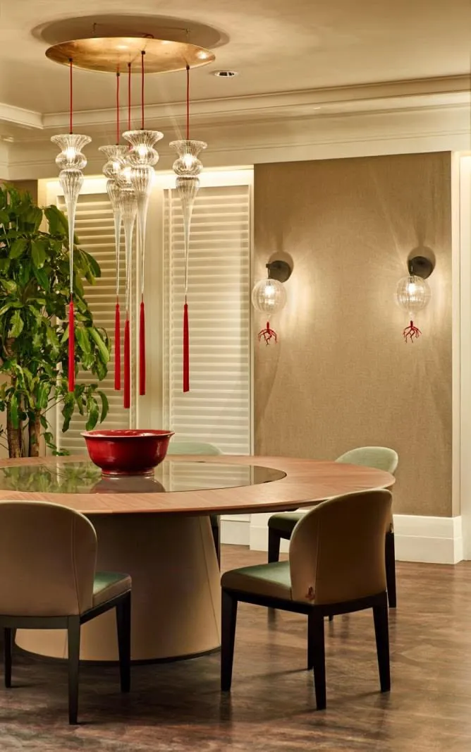 Lamp-lit interior from a lighting maker's project gallery: warm amber glow in a styled room
